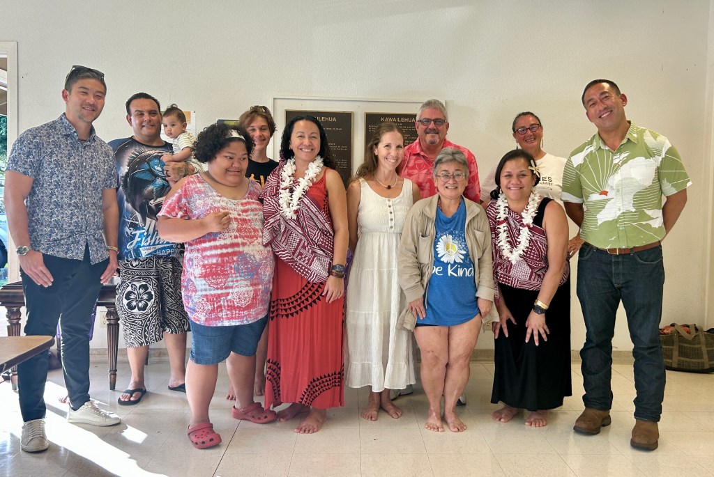 Kawailehua tenants with representatives from the county and YWCA at a spring blessing for the property’s community resource center. Tenants have fought to get that resource center relaunched since the housing authority took back the space for maintenance needs. 
