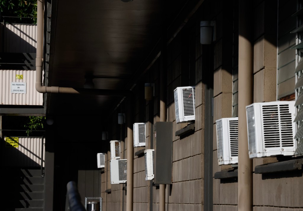 Window air-conditioning units are seen at a Young Street apartment complex, Monday, Oct. 26, 2026, in Honolulu. (Jamm Aquino/Civil Beat/2026)
