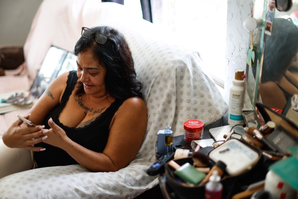Kēhau Manijo cries while going through photos of herself and Tommy Manijo at her residence, Friday, Oct. 2, 2026, in Waiʻanae. (Jamm Aquino/Civil Beat/2026)